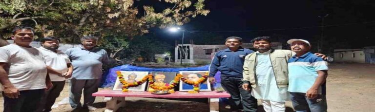people paying tribute to leaders with garlanded portraits during night event Maharashtra jayanti celebration