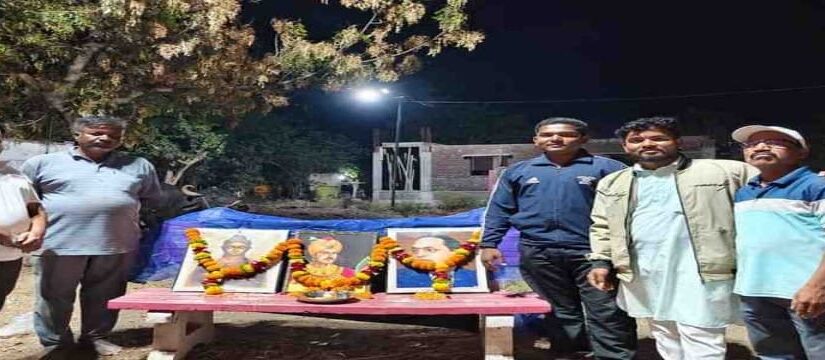 people paying tribute to leaders with garlanded portraits during night event Maharashtra jayanti celebration
